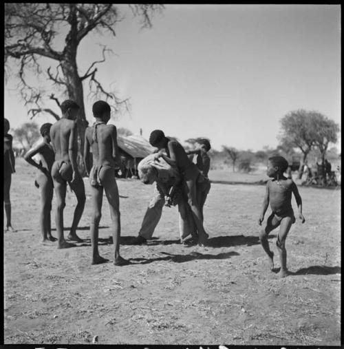 Group of boys playing with John Marshall, including /Gishay (son of "Old Gau"), ≠Toma (son of Gau), !Naishi, and //Ao (son of "Old ≠Toma" of Band 2)