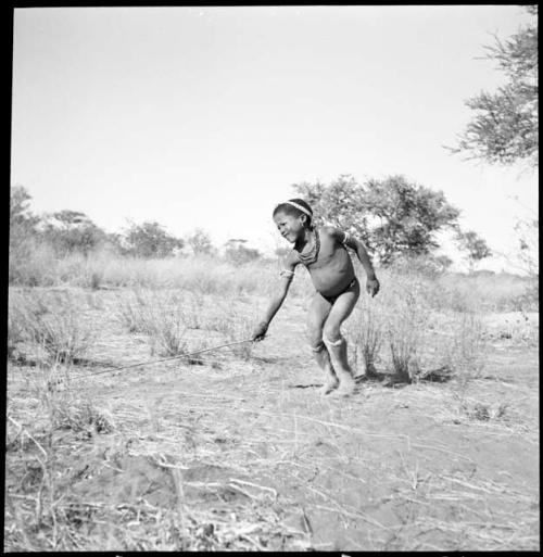 Boy pushing a toy car made from veldkos