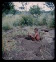 Poison: Man sitting inside of a hole with a digging stick