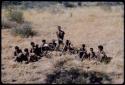 Food Gathering, General: Group of women sitting and holding !kxoa (water roots)