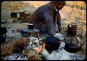 Edward Hartley cooking in the expedition camp