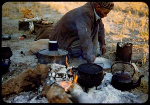 Edward Hartley cooking in the expedition camp