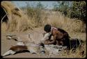 Scraping Skin: Man scraping a gemsbok skin