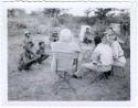 Group of people sitting and being interviewed by Laurence Marshall and Lorna Marshall, with Kernel Ledimo translating