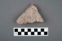 Dark grey body sherd, coarse paste, grit and shell temper, both surfaces weather