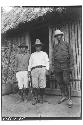 Three men standing in front of building