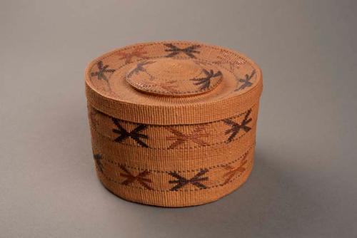 Twined basket with bands of wing shaped designs in black and red.