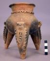 Tripod pottery vase - incised applique decoration