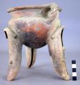 Tripod pottery vessel with rattles in legs