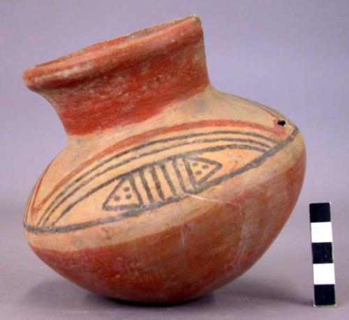 Pottery jar, red base with black and red ornament on upper yellow zone