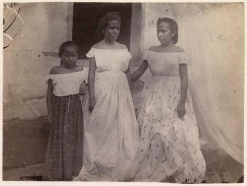 Two women and a girl standing