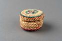 Miniature wrapped twined grass basket (A) with lid (B); bird motif