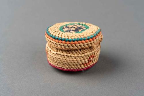 Miniature wrapped twined grass basket (A) with lid (B); bird motif