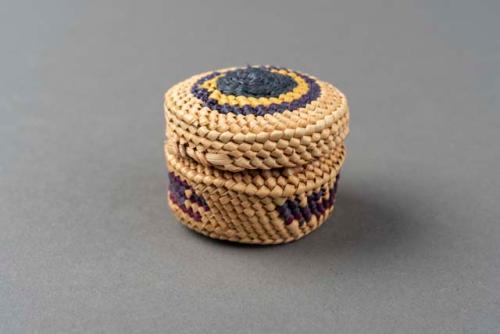 Miniature wrapped twined grass basket (A) with lid (B); bird motif