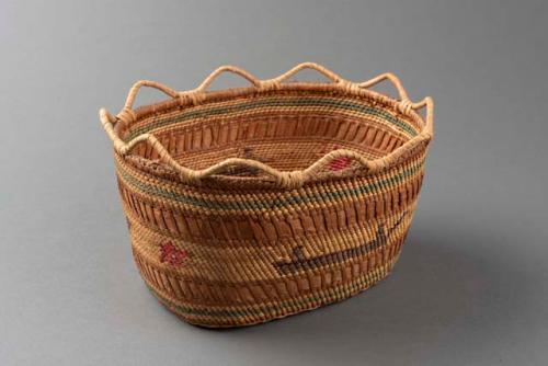 Wrapped twined oval grass basket with scalloped rim