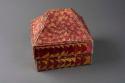 Red and yellow basketry box with lid shaped like a pyramid