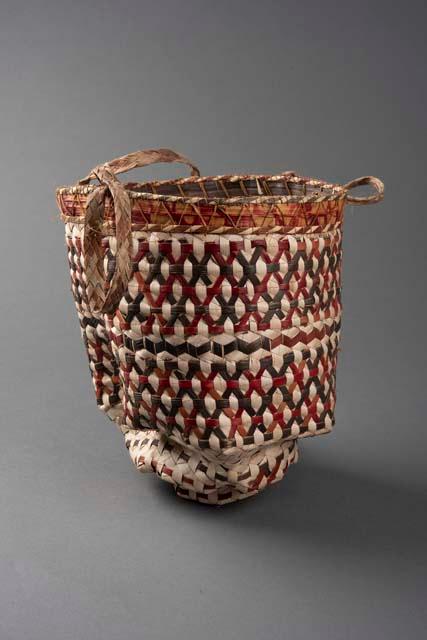 Small carrying basket. Bottom like inverted pagoda. Decorated in red +