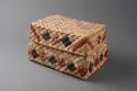 Basketry box and lid of coarse fibres, rectangular. Decorated with red+