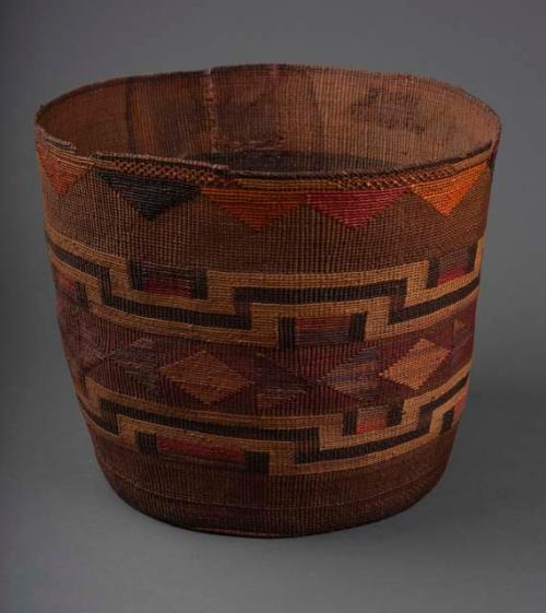 Large basket--geometric design of yellow, red, orange, brown in false embroidery