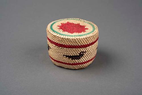 Small basket with designs in red, green, and black - cedar bark bottom