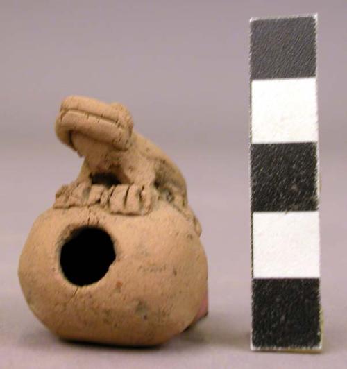 Ceramic whistle, lizard atop hollow ball