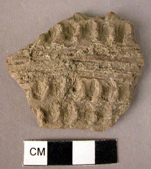 Potsherd - finger-tip impressions and white incrustations in grooves