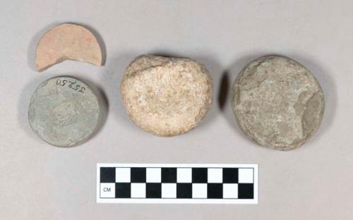 Ground stone discs with depressions in center