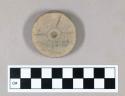 Ground stone disc, incised design and central punctate