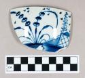 Ceramic, pearlware rim sherd with hand painted blue decoration