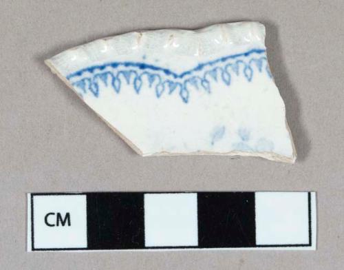 Ceramic, whiteware rim sherd with blue transferprint and molded rim