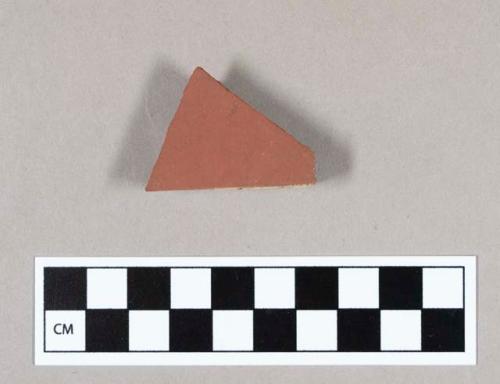 Ceramic, terracotta tile fragment with several finished sides and mortar along edge