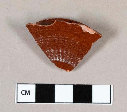 Ceramic, Astbury type, engine turned lid fragment, red body with clear lead glaze