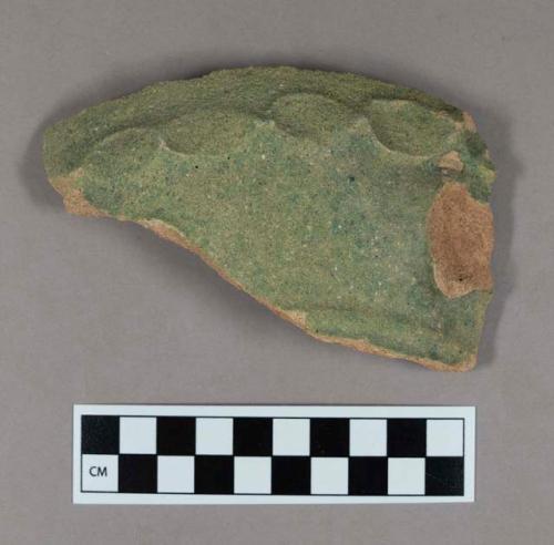 Ceramic, buff coarse earthenware body sherd with "pie crust" molded decoration, and loss of element (possibly handle), green exterior and interior matte glaze