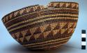 Basketry cap. alternating bands and triangular motifs. 8" diameter. damaged rim.