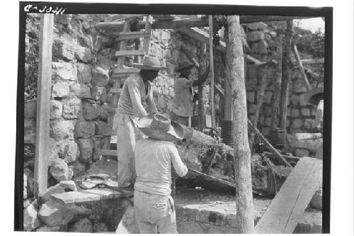 Caracol. Repair of cornice of lower platform N. of stairway.