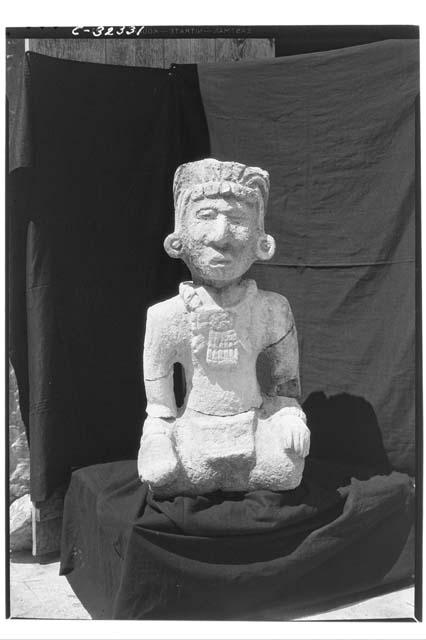 Caracol - seated human figure in stone, north stope, second terrace, specimen #