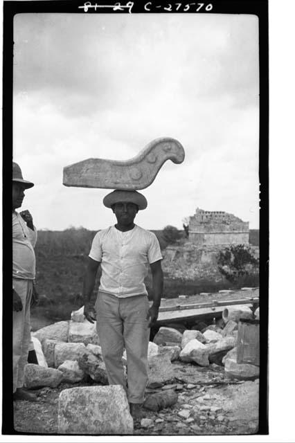 Caracol. Laborer carrying stone nose for mask panel over S. doorway