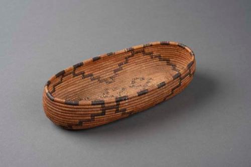 Oval basket (boat-shaped) with black on natural geometric design