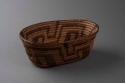 Coiled open weave oval basketry bowl of cattail reed