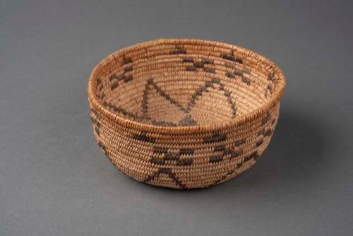 Coiled bowl-shaped basket with straight sides and floral motif