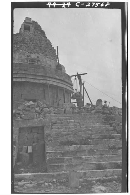 Caracol. Showing mask panel over W. doorway and stone being raised for restorati