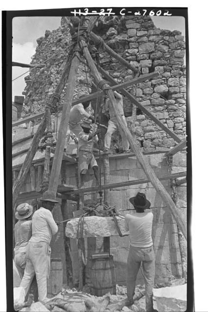 Caracol. Raising stone block for restoration in 5-member cornice.