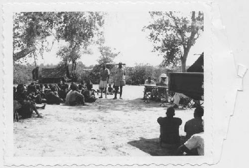 People sitting and standing in the expedition camp