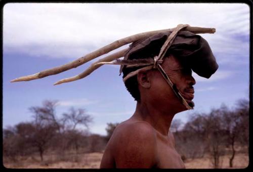 !Kxam dancing in the Eland Dance, wearing horns tied to his head with thongs, close-up