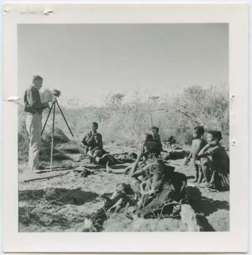 Group of women sitting, being filmed by John Marshall, including !Ungka, //Kushay (her sister) and /Naoka (wife of "/Qui Hunter" of Band 2)