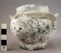 Ceramic jar, black ware w. white mineral encrustation, incised