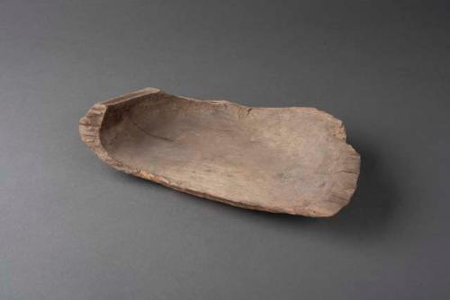 Fragment of oval wooden dish, perforated for suspension - used in serving food