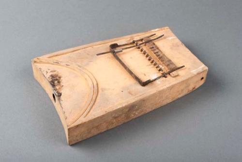 Thumb piano; carved wood body; incised design; perf'd; metal key & supports