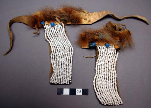 Woman's hair ribbon of buckskin covered with marmot skin and beads.