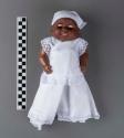 Plastic doll, one of a pair of twins wearing Santeria-Vodou white clothes